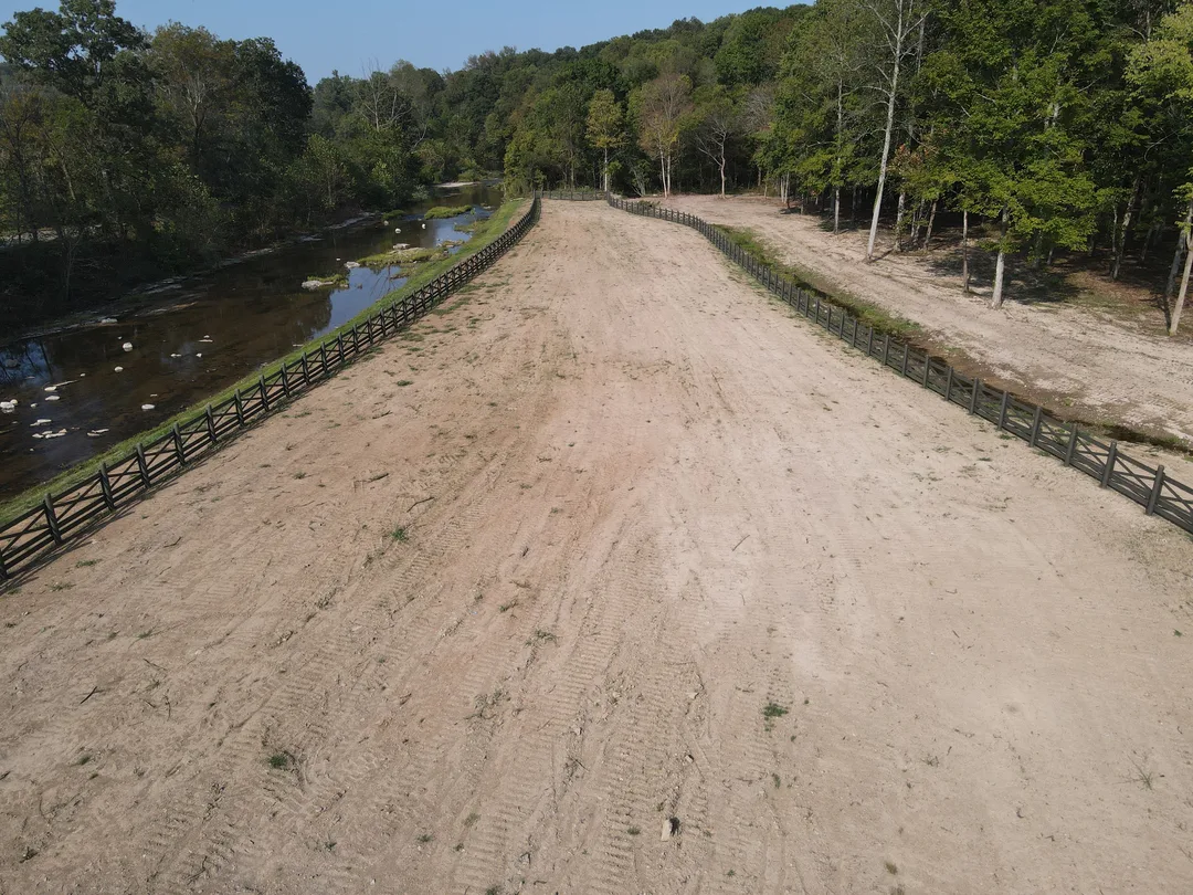 Cleared corridor along a creek after brush removal