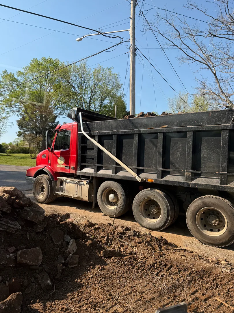 Dump truck unloading dirt at a job site
